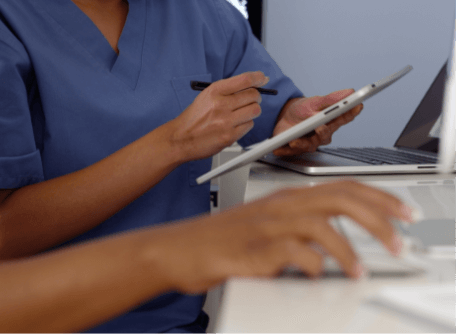 a healthcare professional holding a digital tablet