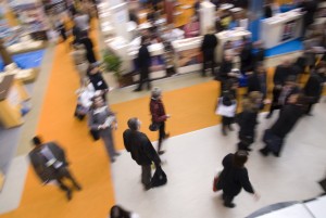 Visitors passing by stands at exhibition